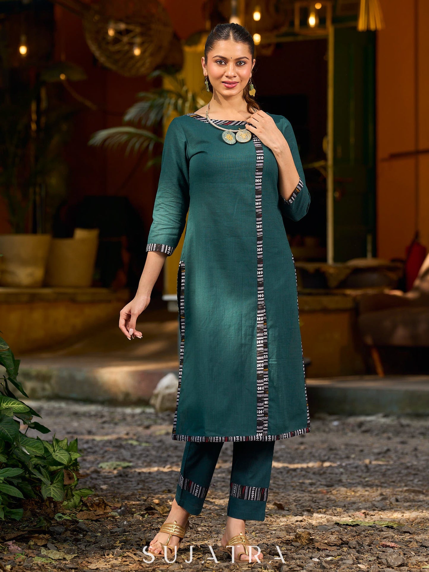 bottle green solid kurta with a refined ajrakh edging.