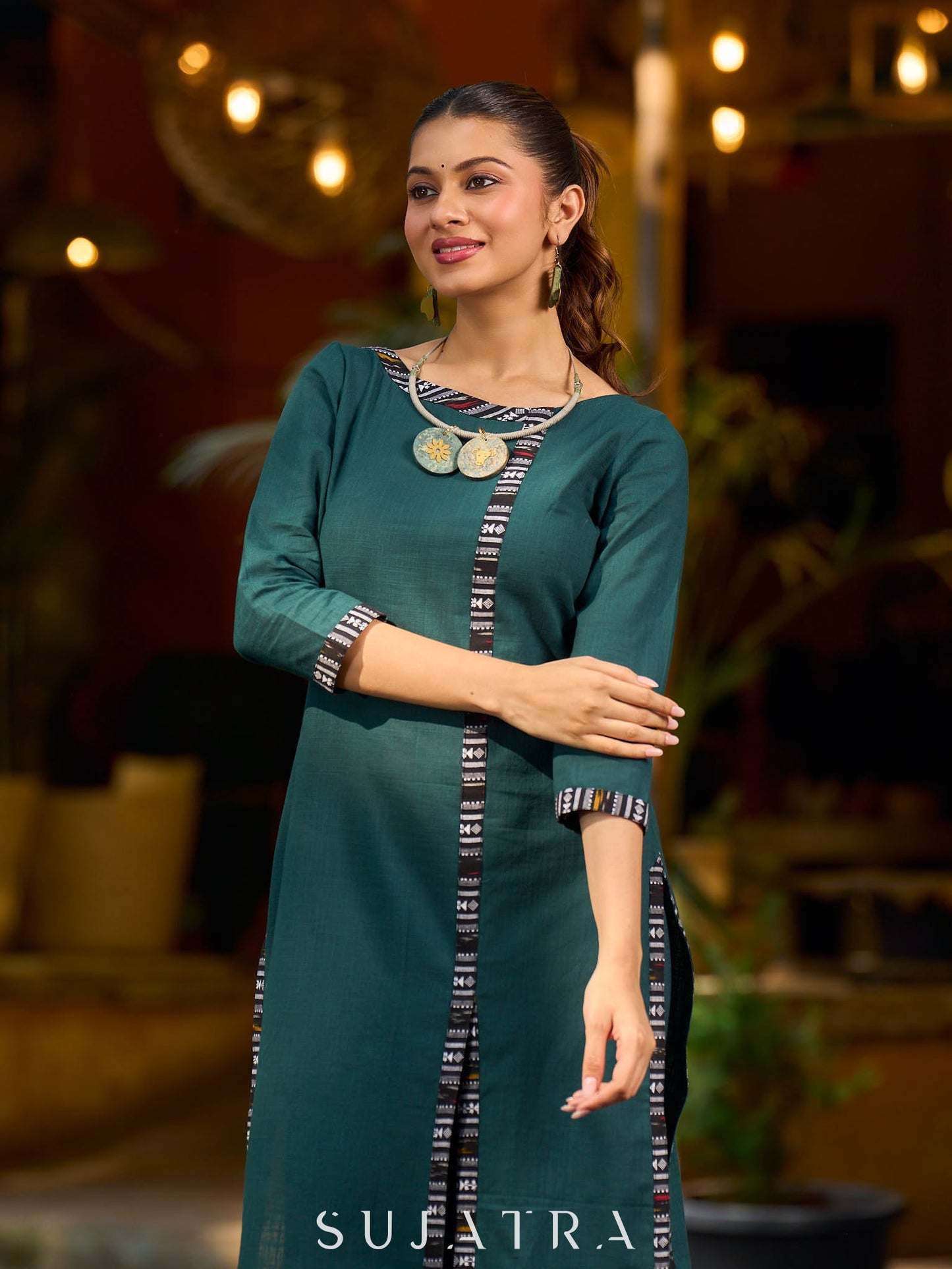 bottle green solid kurta with a refined ajrakh edging.