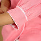 Delicate hand painting enhances this baby pink collared cotton top