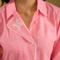 Delicate hand painting enhances this baby pink collared cotton top