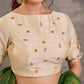 Blouse en coton et soie crème avec broderie florale faite main sur l'ensemble et les manches