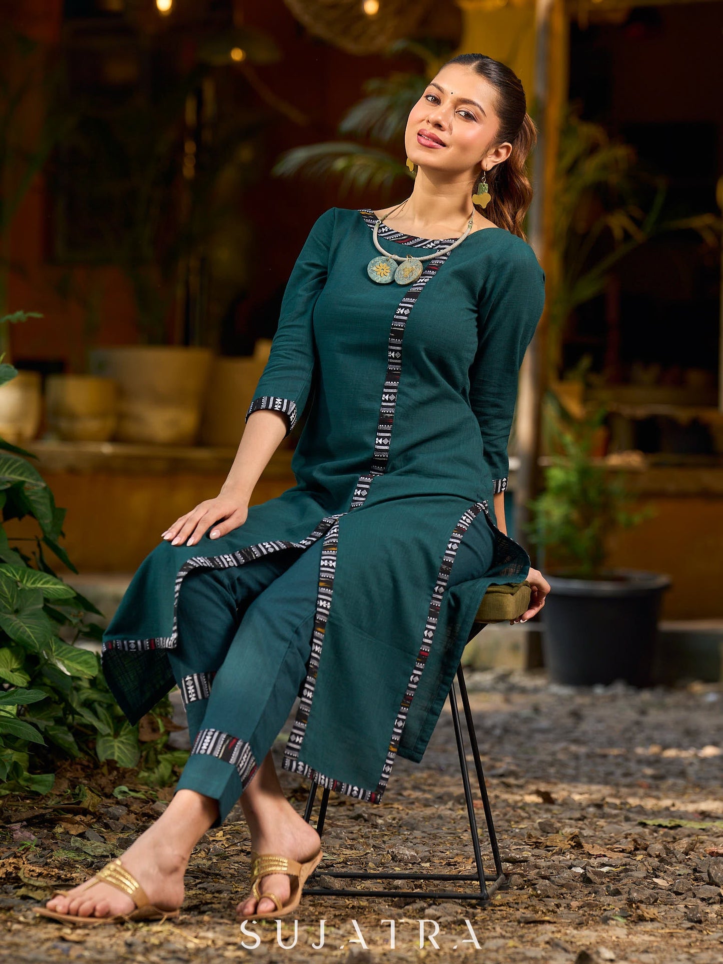 bottle green solid kurta with a refined ajrakh edging.