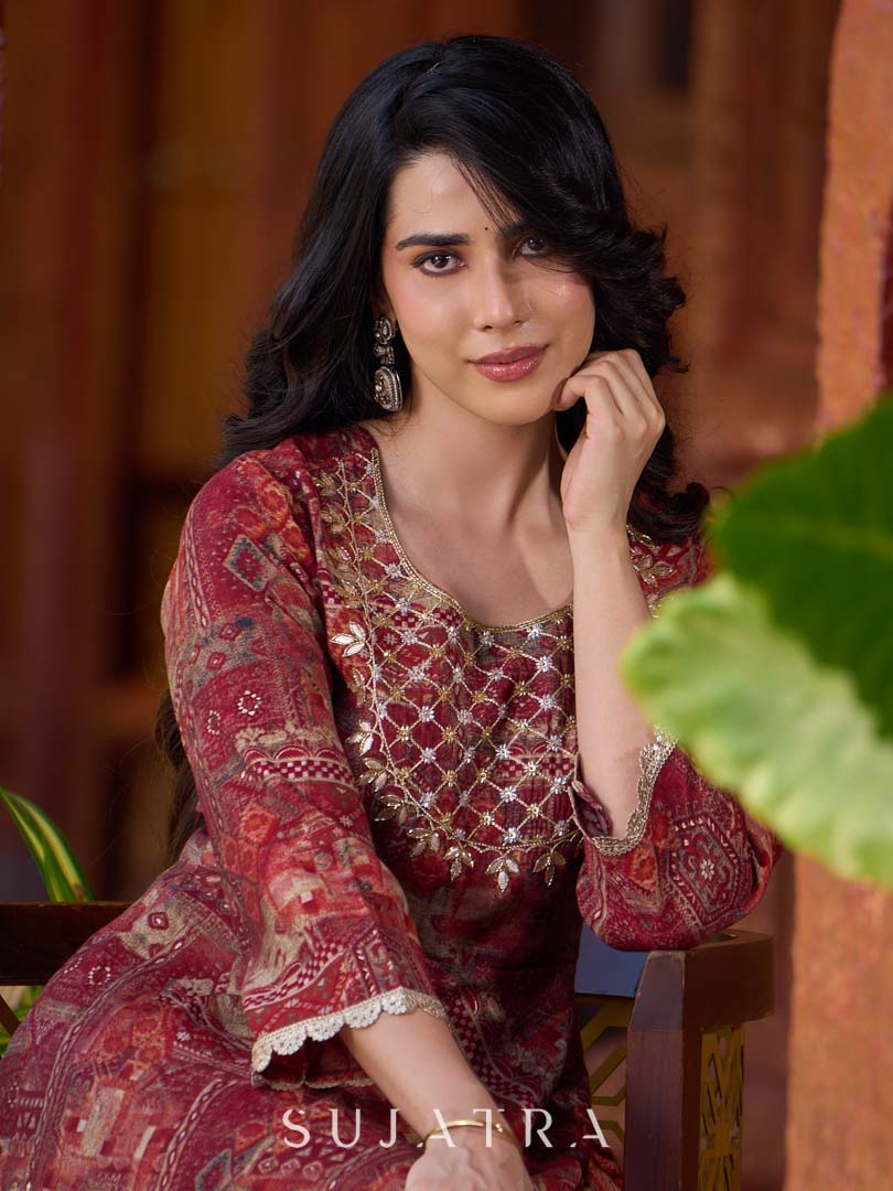 Exquisite deep maroon printed kurta with a graceful bias silhouette, intricate handwork on the yoke, and scalloped sleeve detailing.