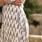 Modern white and grey Ikat shirt dress elevated with an asymmetrical checkered Ikat collar and contrast black accents.