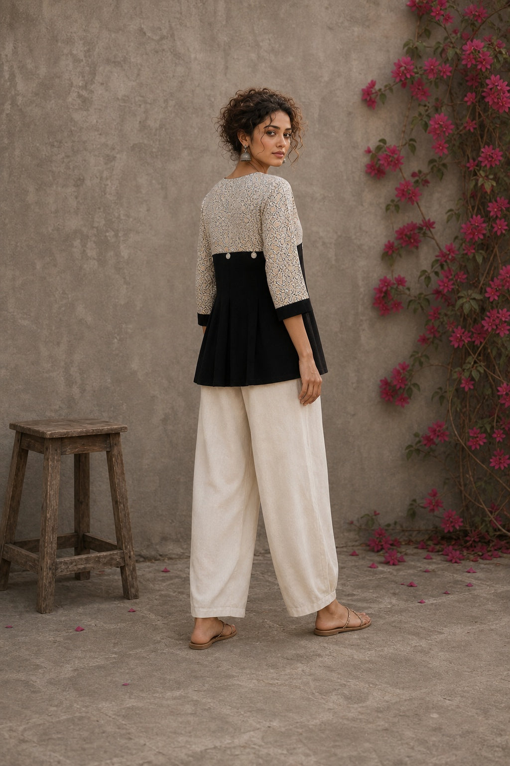 Black Jaipur floral printed yoke top featuring black pintuck body, three-quarter sleeves, and delicate ruffled sleeve edging.