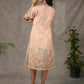Peach Kalamkari-inspired shirt dress with soft beige accents.
