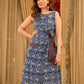 Chic indigo wrap-style dress featuring animal-inspired motifs with a striped belt and refined accents.