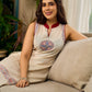 Off-white dress featuring intricate Madhubani artwork and a maroon Mandarin collar.