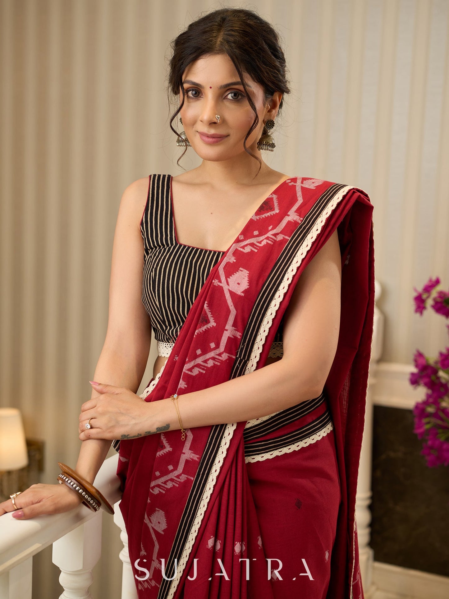 Exquisite Jamdani saree in regal red with intricate motifs and lace borders