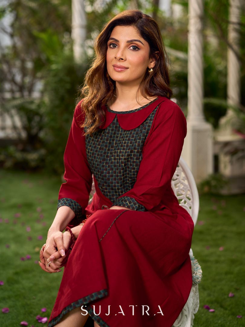 Chic maroon dress featuring a contrasting teal neck patch with charming Peter Pan collar details