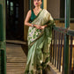 Muted Green Tussar Silk Saree with Delicate Floral Artwork and Classic Border