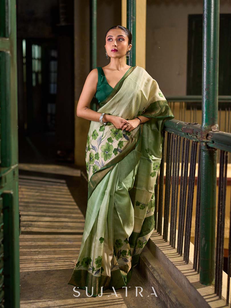 Muted Green Tussar Silk Saree with Delicate Floral Artwork and Classic Border