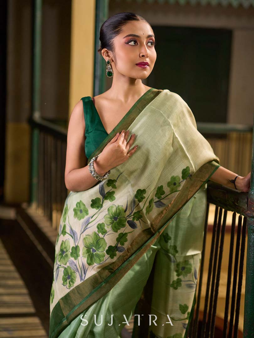 Muted Green Tussar Silk Saree with Delicate Floral Artwork and Classic Border