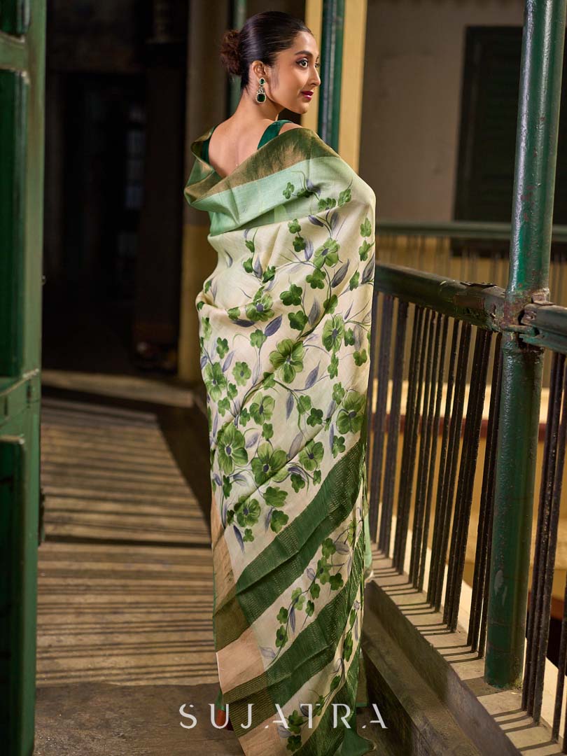 Muted Green Tussar Silk Saree with Delicate Floral Artwork and Classic Border