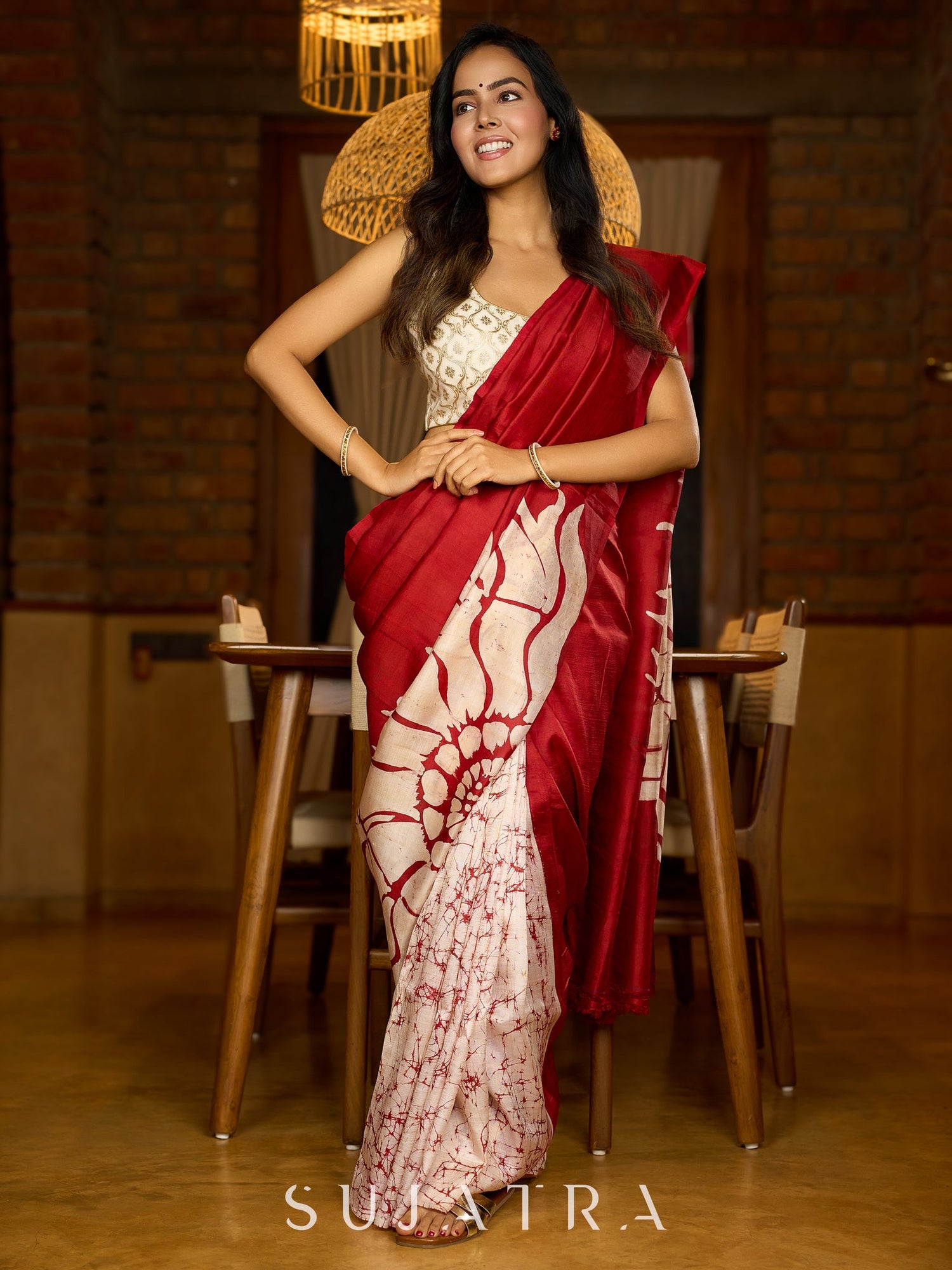 Artisanal crimson silk saree featuring heritage batik floral designs