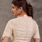 Blouse en coton et soie crème avec encolure et manches brodées de motifs floraux colorés