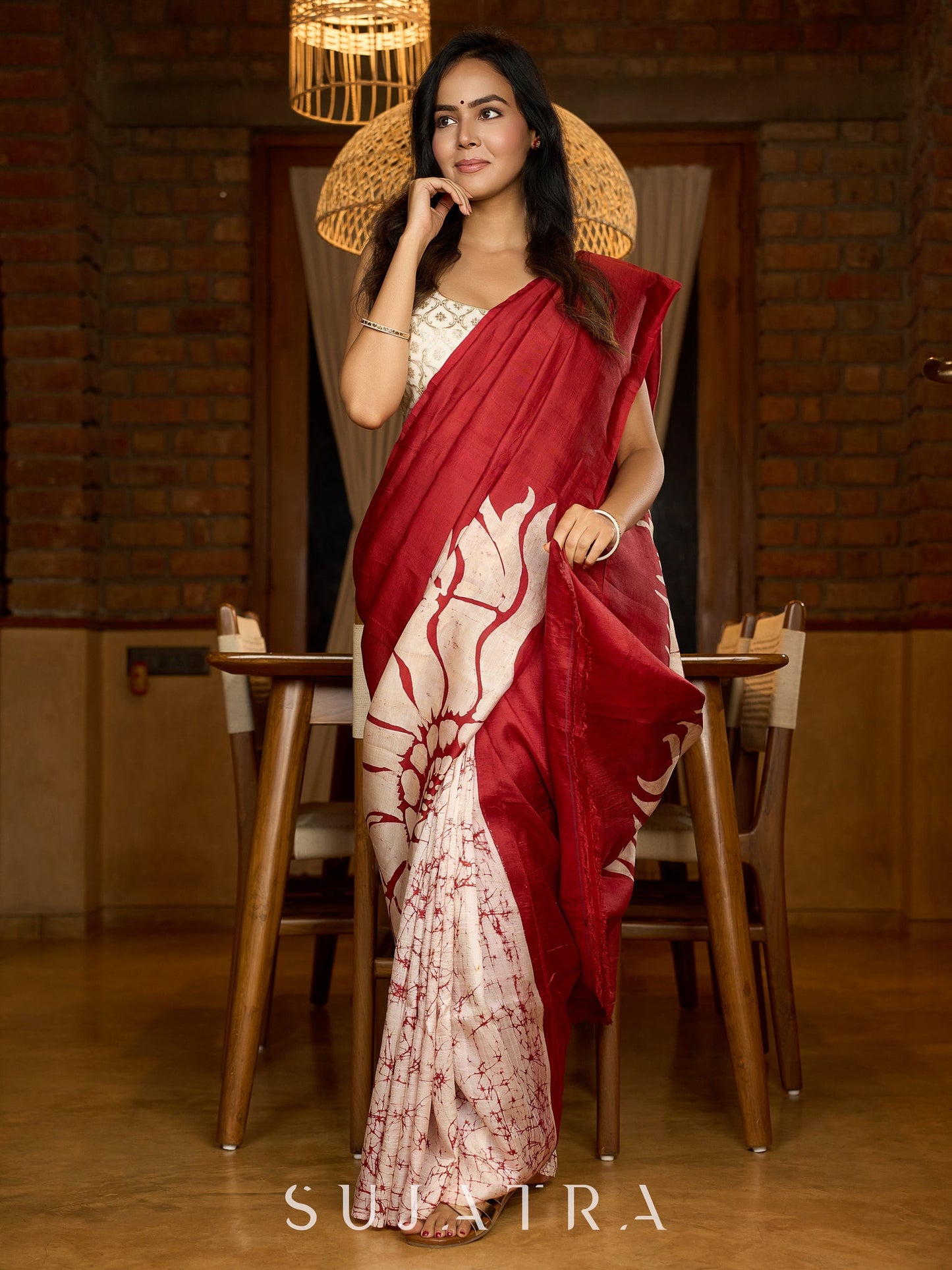 Artisanal crimson silk saree featuring heritage batik floral designs