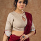 A delicate beige hue blouse with asymmetrical keyhole neckline to create a stunning piece for work or leisure.