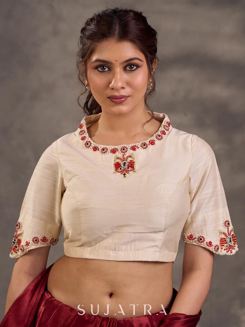 Blouse en coton et soie crème avec encolure et manches brodées de motifs floraux colorés