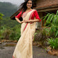 Elegant cream chanderi saree with subtle red border, featuring hand-painted Durga art
