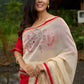 Elegant cream chanderi saree with subtle red border, featuring hand-painted Durga art