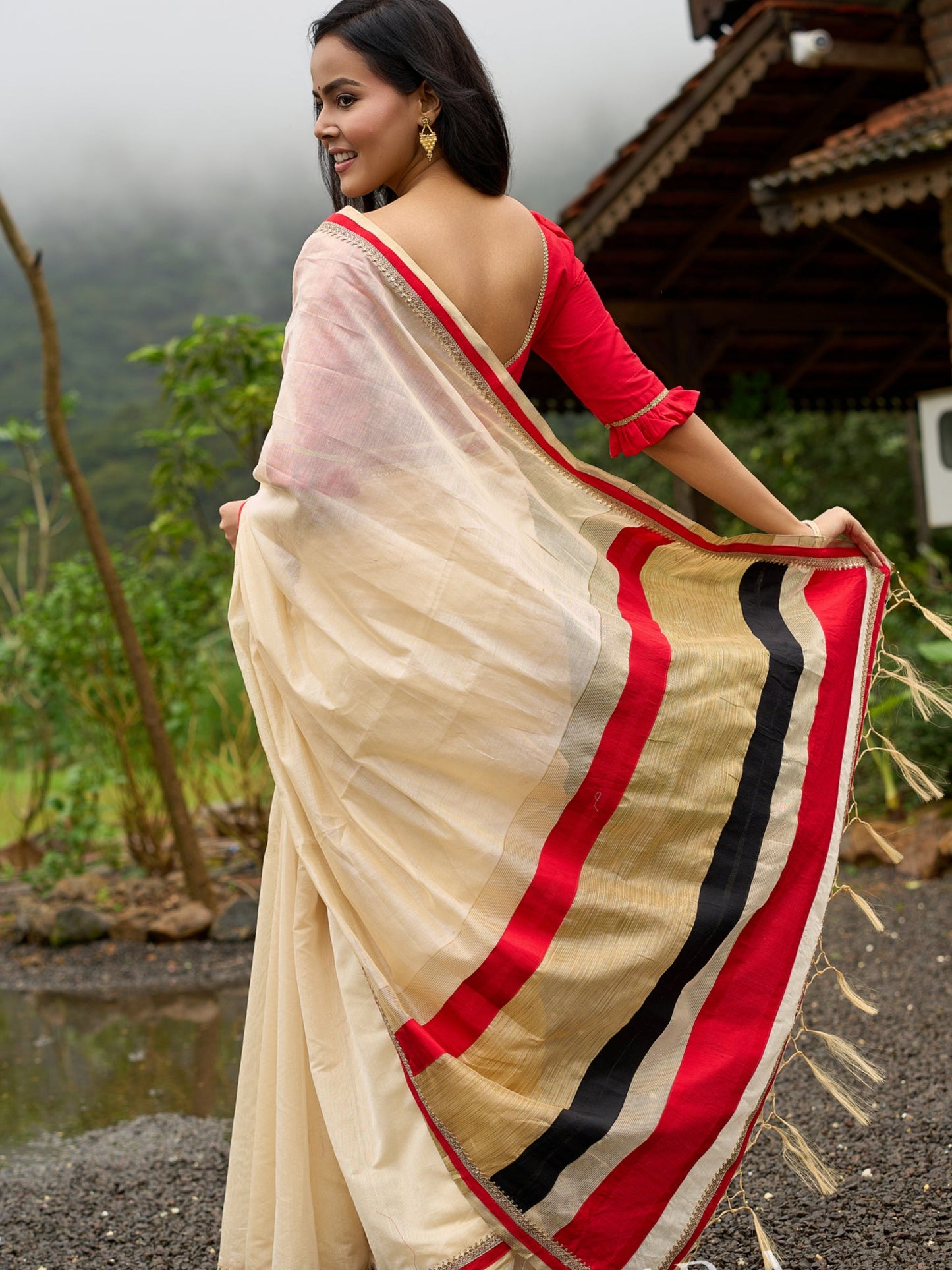 Elegant cream chanderi saree with subtle red border, featuring hand-painted Durga art