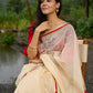 Elegant cream chanderi saree with subtle red border, featuring hand-painted Durga art