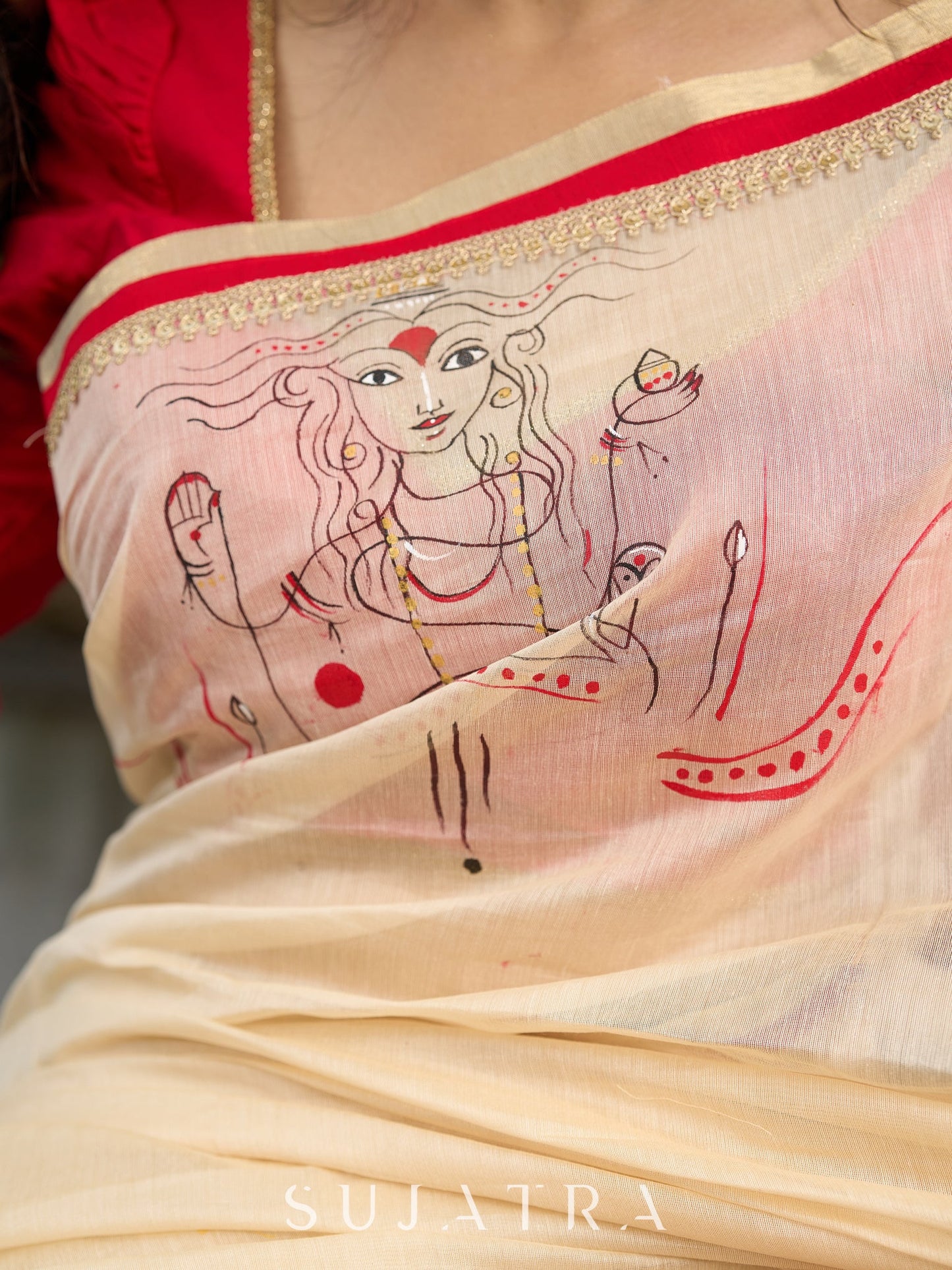 Elegant cream chanderi saree with subtle red border, featuring hand-painted Durga art
