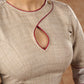 A delicate beige hue blouse with asymmetrical keyhole neckline to create a stunning piece for work or leisure.