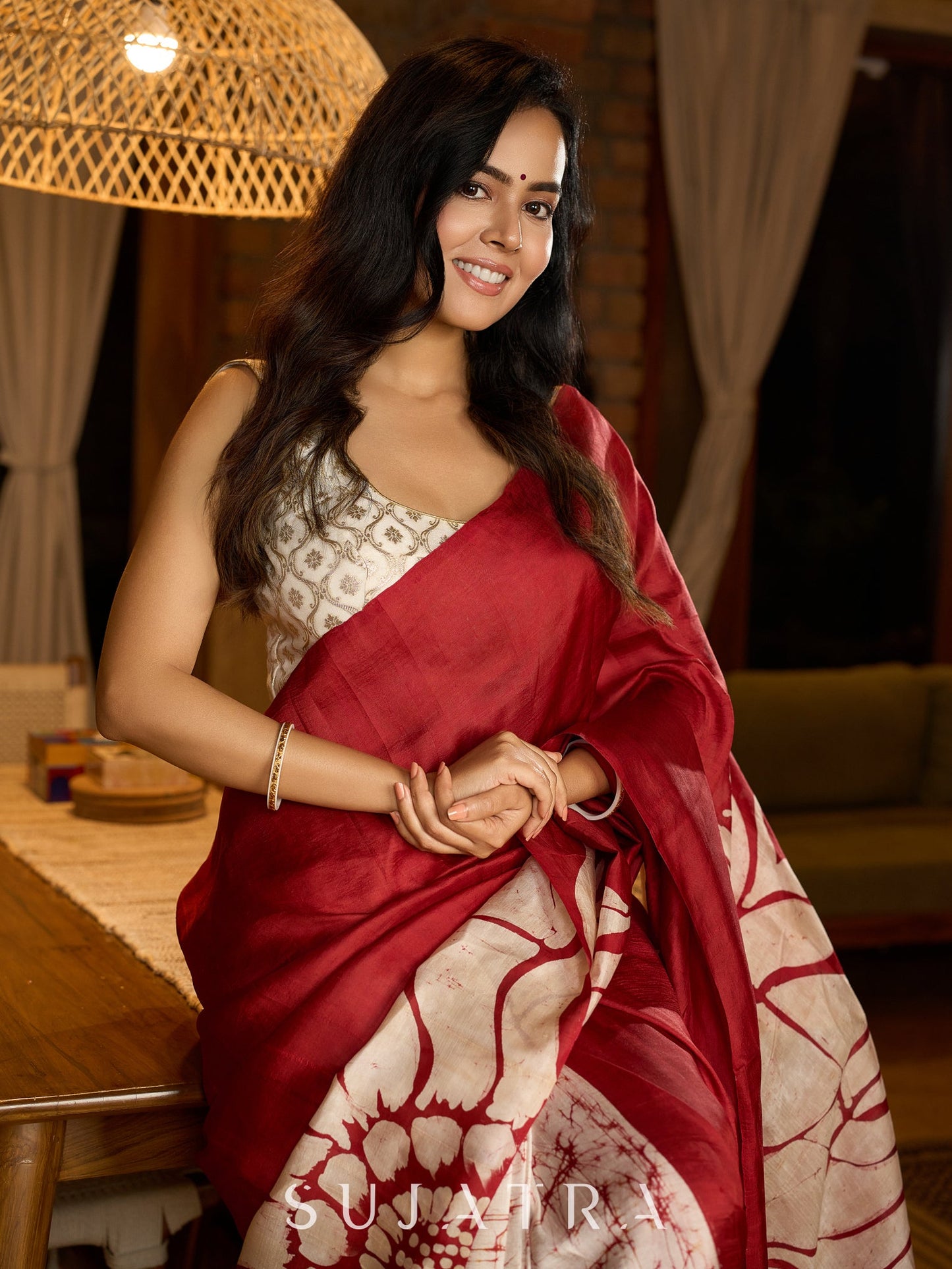Artisanal crimson silk saree featuring heritage batik floral designs