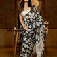 Artisanal black silk saree featuring intricate hand-drawn Kalamkari style motifs