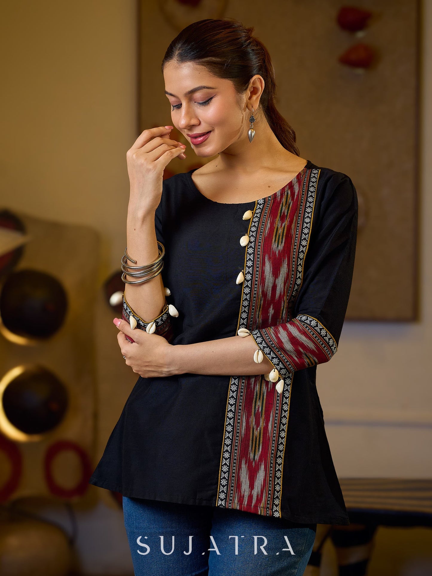 Sleek Black Cotton Silk Top Adorned with Ikat Borders and Exquisite Cowrie Embellishments