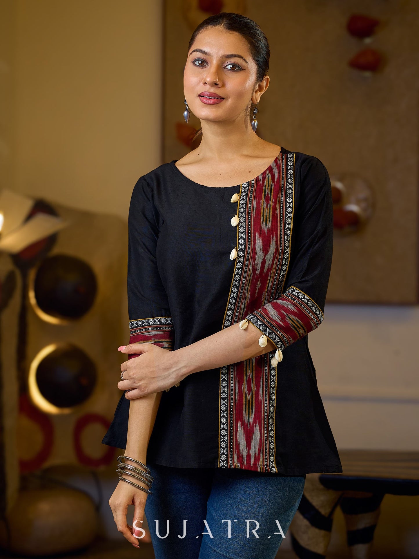 Sleek Black Cotton Silk Top Adorned with Ikat Borders and Exquisite Cowrie Embellishments