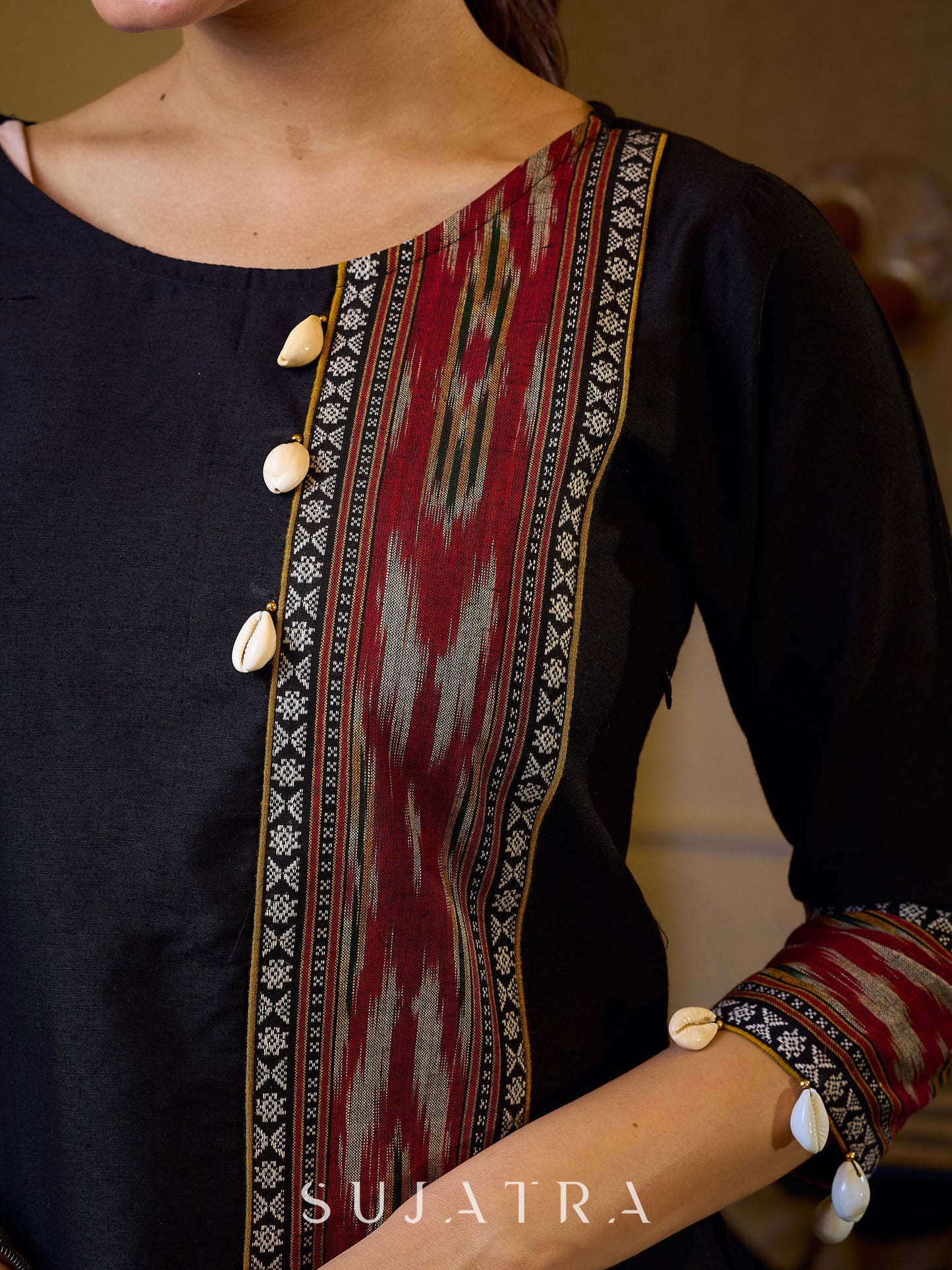 Sleek Black Cotton Silk Top Adorned with Ikat Borders and Exquisite Cowrie Embellishments