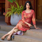 Amber crimson blossom printed kurta with golden pearl handwork on the yoke and dainty tie-up neck details.