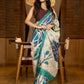 Classic ivory pure silk saree highlighted by teal borders and hand batik artistry
