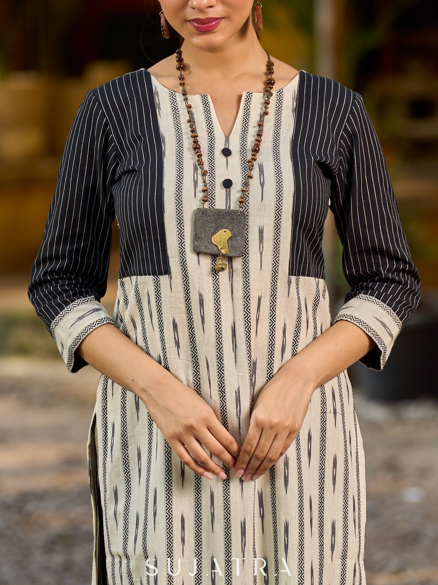 Timeless monochrome Ikat kurta enhanced with stripe details.