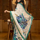 Classic ivory pure silk saree highlighted by teal borders and hand batik artistry