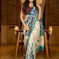 Classic ivory pure silk saree highlighted by teal borders and hand batik artistry