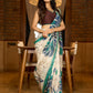 Classic ivory pure silk saree highlighted by teal borders and hand batik artistry