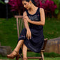 Graceful Black Rayon Pleated Dress with Script Art and Painted Hemline