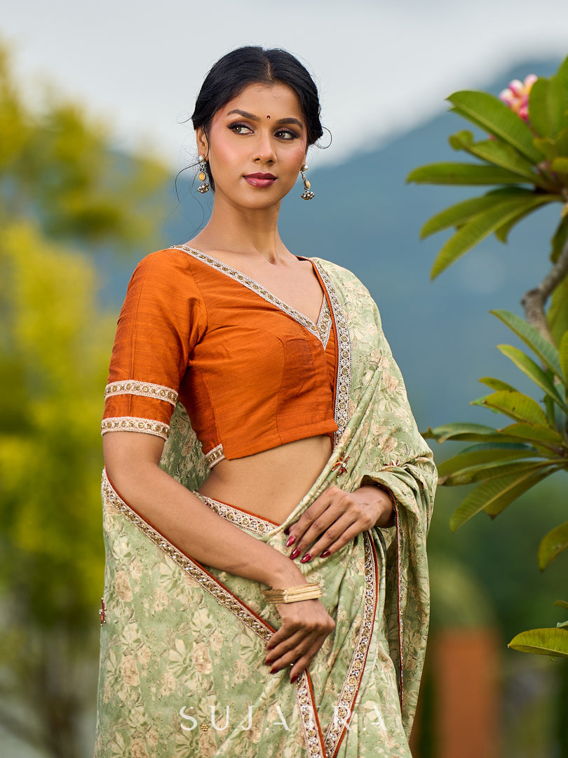 Enchanting Sage Green Saree with All-Over Foil Floral Print & Golden-Orange Trim Detail with Hand Embroidered Pallu