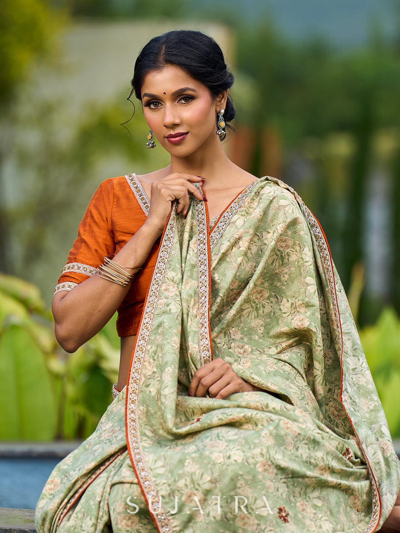 Enchanting Sage Green Saree with All-Over Foil Floral Print & Golden-Orange Trim Detail with Hand Embroidered Pallu