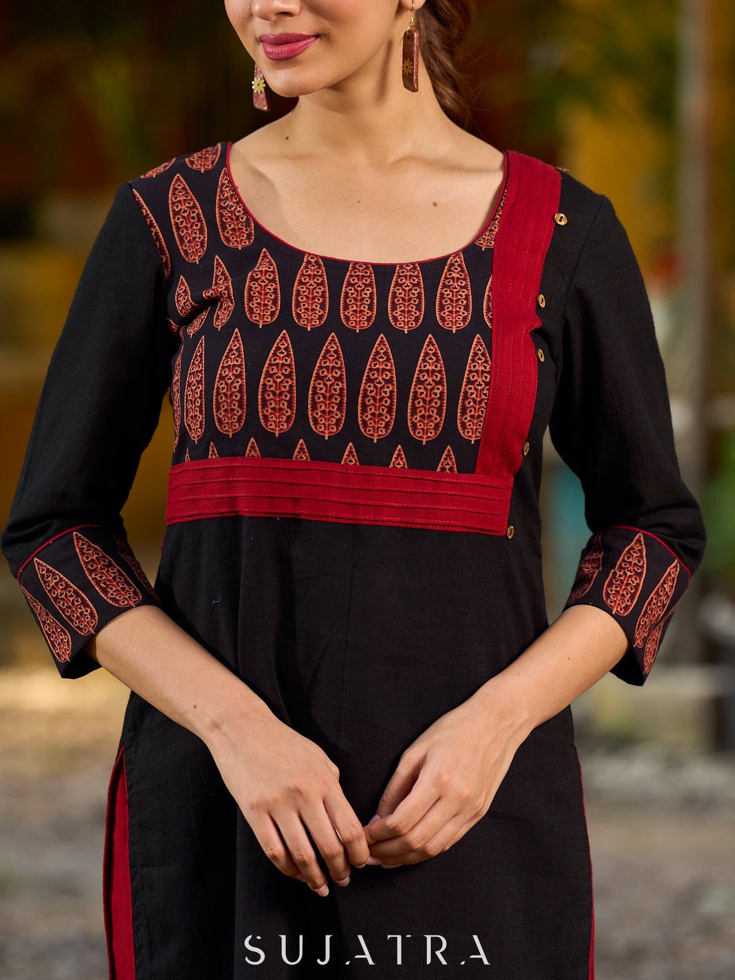 Elegant black kurta featuring an Ajrakh leaf patch across the neck panel