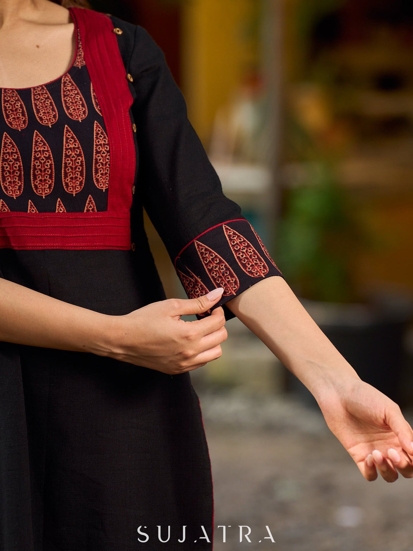 Elegant black kurta featuring an Ajrakh leaf patch across the neck panel