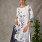 White and black floral dress with pearl embellishments and black accents.
