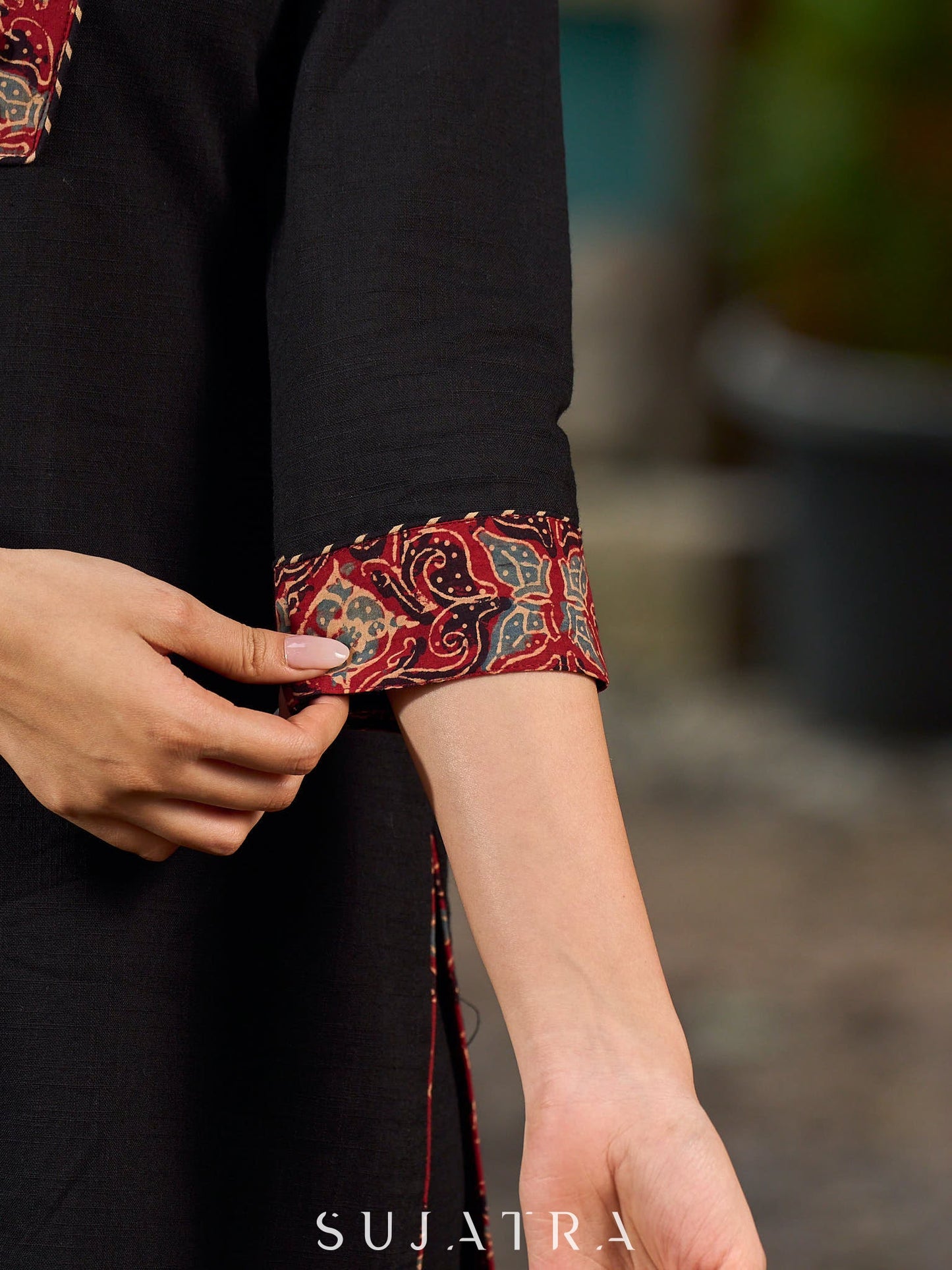 elegant black cotton kurta with beautifully crafted ajrakh panel and subtle stripe piping accents