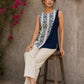 Contemporary off white and navy hand block print top featuring striking geometric motifs, an asymmetric layered silhouette, and effortless elegance