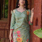 Soft green printed kurta with vibrant floral motifs, highlighted with hand embroidery and bright magenta accents.