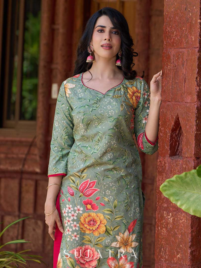 Soft green printed kurta with vibrant floral motifs, highlighted with hand embroidery and bright magenta accents.